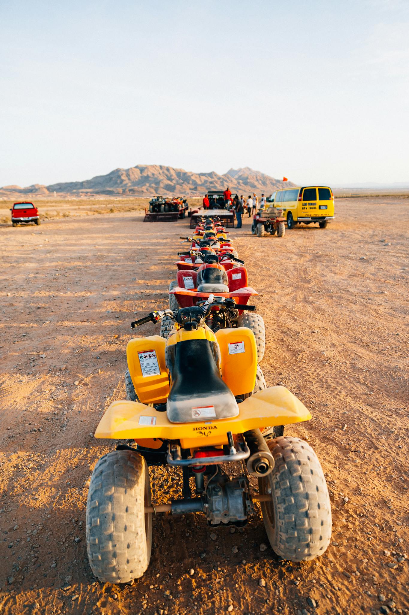 A lineup of ATVs in the Las Vegas desert awaits an off-road adventure tour.